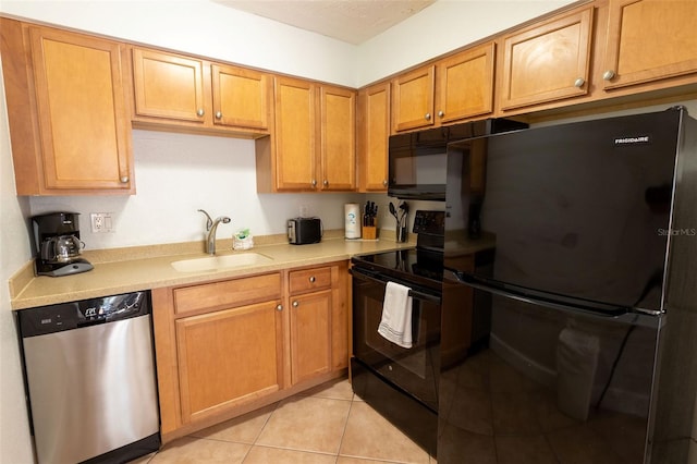 kitchen with sink, light tile floors, and black appliances