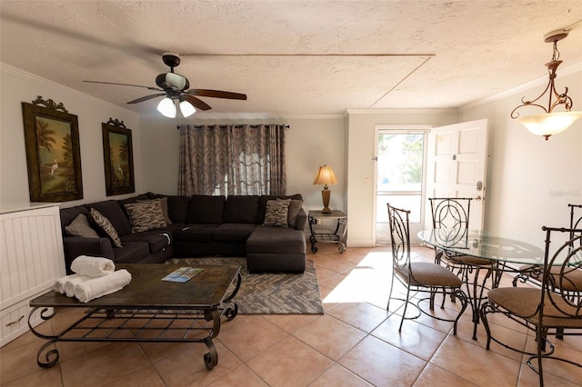 living room with light tile floors, a textured ceiling, crown molding, and ceiling fan