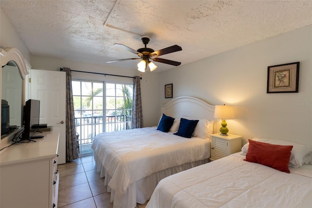 tiled bedroom with a textured ceiling, access to exterior, and ceiling fan