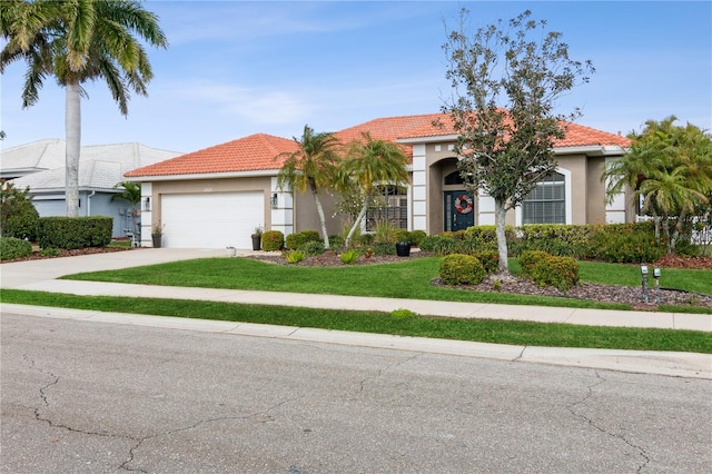 view of front facade with a garage and a front yard