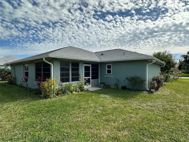 rear view of property with a yard