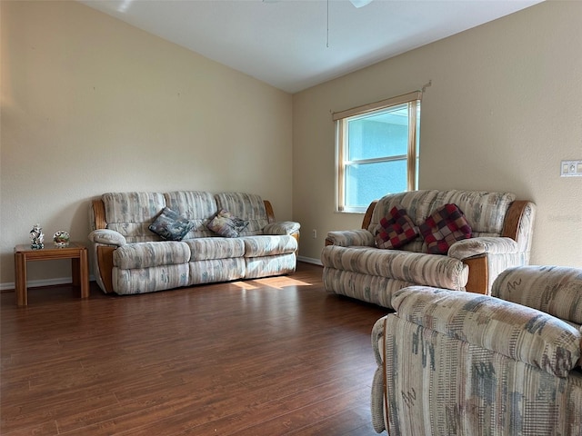 living room featuring ceiling fan and dark hardwood / wood-style floors