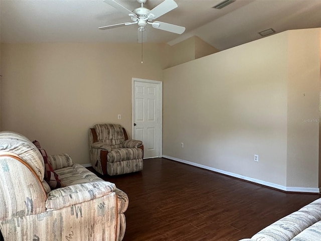 living area with ceiling fan, vaulted ceiling, and dark hardwood / wood-style flooring