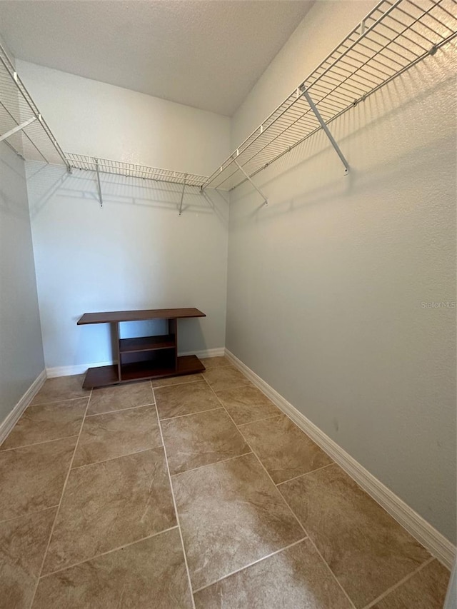 walk in closet featuring tile flooring