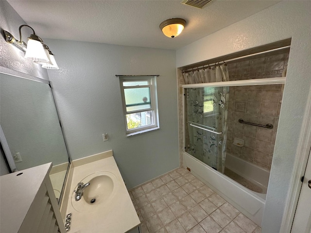 bathroom with vanity, a textured ceiling, and tile floors