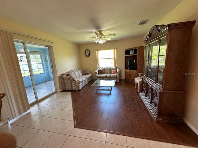 living room featuring light hardwood / wood-style flooring and ceiling fan