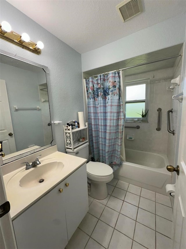 full bathroom with shower / bath combo with shower curtain, toilet, vanity, a textured ceiling, and tile floors