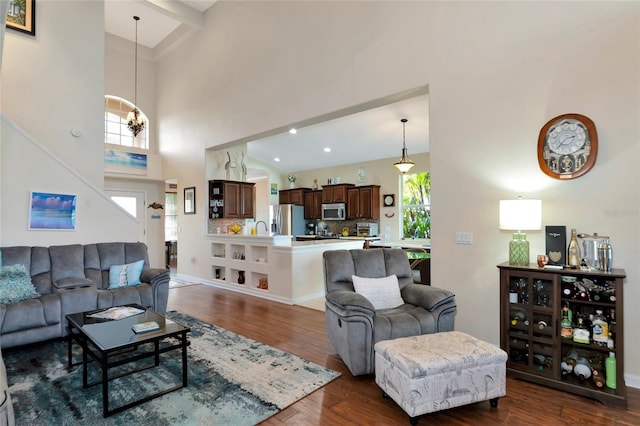 living room featuring beamed ceiling, high vaulted ceiling, sink, a chandelier, and dark hardwood / wood-style flooring