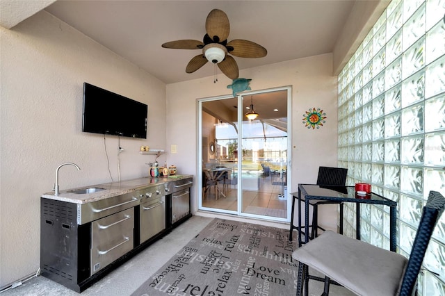 exterior space with ceiling fan and sink