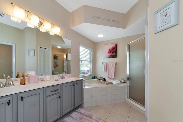 bathroom featuring tile floors, dual bowl vanity, and separate shower and tub