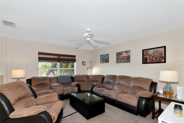 carpeted living room with ceiling fan