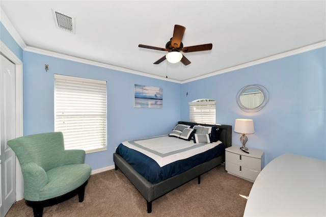 carpeted bedroom with ceiling fan, ornamental molding, and multiple windows