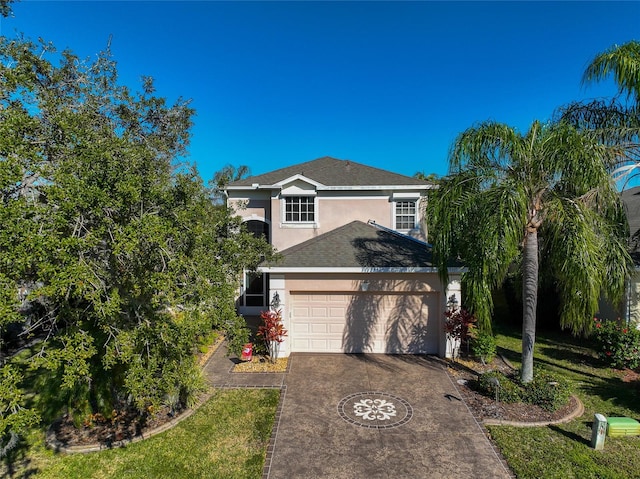 view of front of property with a front lawn and a garage