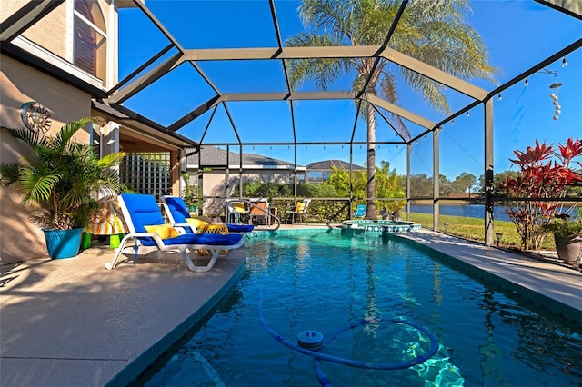 view of swimming pool featuring a patio area and a lanai