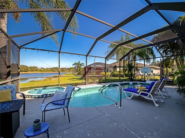 view of pool featuring an in ground hot tub, a water view, glass enclosure, and a patio area