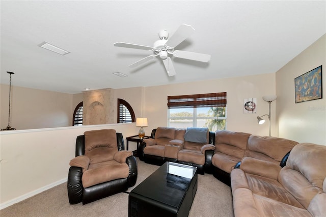 carpeted living room with ceiling fan