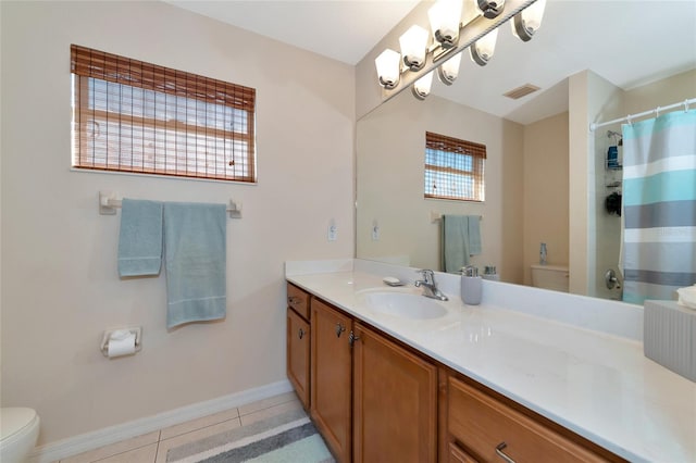 bathroom with tile floors, oversized vanity, and toilet