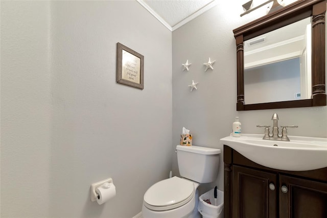 bathroom with lofted ceiling, toilet, vanity, and crown molding