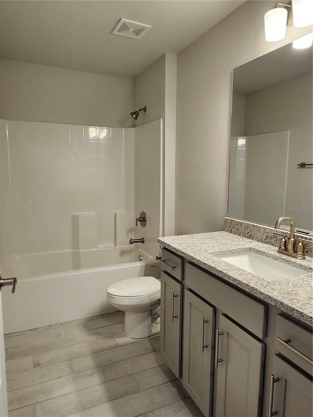 full bathroom with vanity, shower / bath combination, and toilet