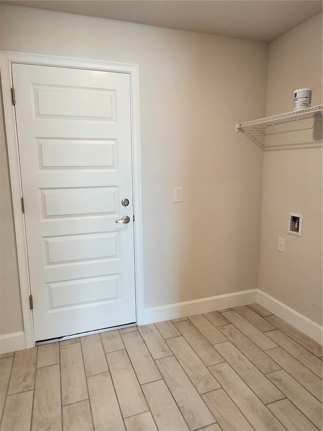 laundry area featuring washer hookup and light hardwood / wood-style floors