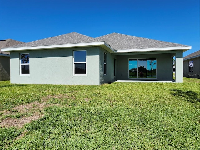 rear view of property featuring a yard