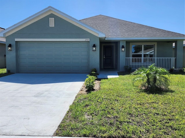 ranch-style house featuring covered porch, a garage, and a front lawn