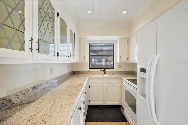 kitchen featuring white cabinetry, light stone counters, white refrigerator with ice dispenser, crown molding, and range