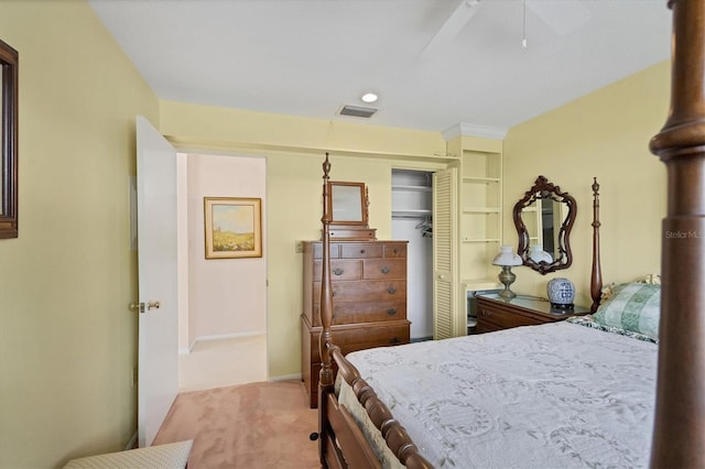 carpeted bedroom featuring ceiling fan and a closet