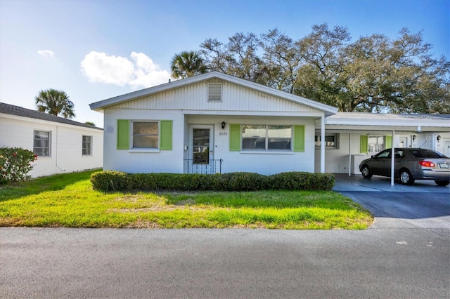 ranch-style house featuring a front yard and a carport