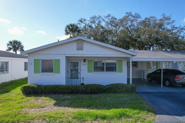 single story home featuring a front yard and a carport