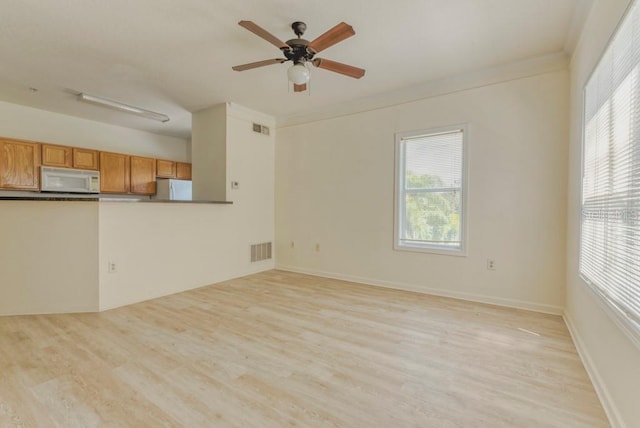 unfurnished living room with ceiling fan and light hardwood / wood-style flooring