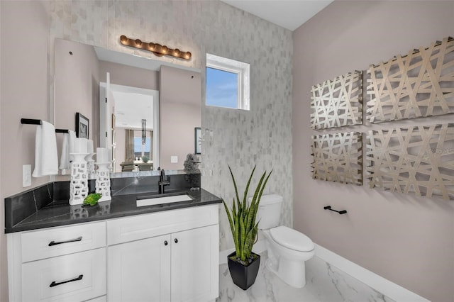 bathroom featuring toilet and vanity