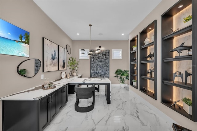 office area featuring light tile floors and built in shelves