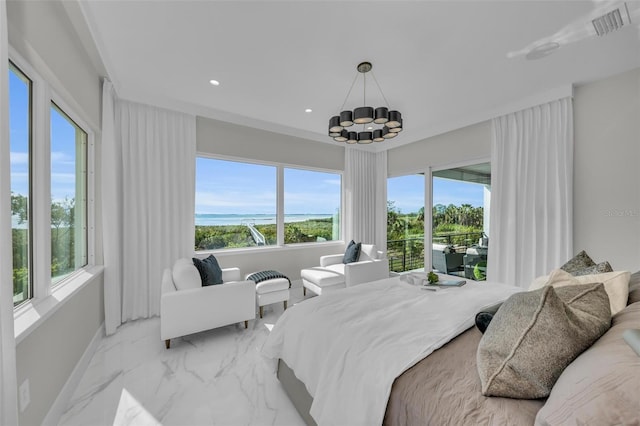 bedroom featuring a chandelier and a water view