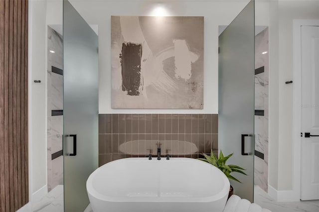 bathroom with a bath and tile floors