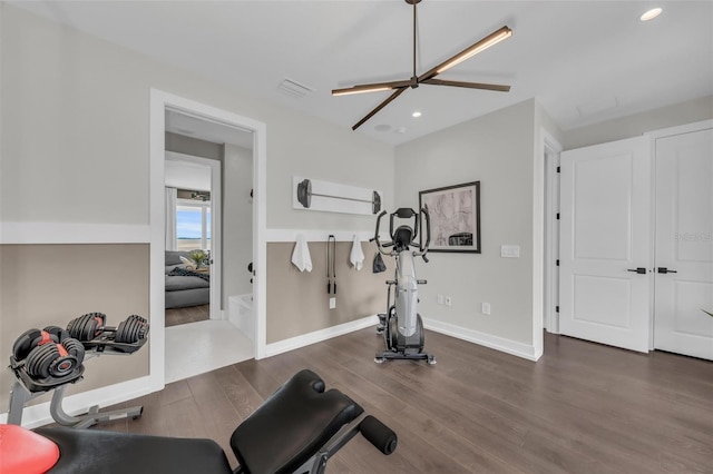 workout room with dark hardwood / wood-style floors and ceiling fan