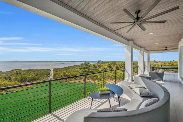 balcony featuring a water view, an outdoor living space, and ceiling fan