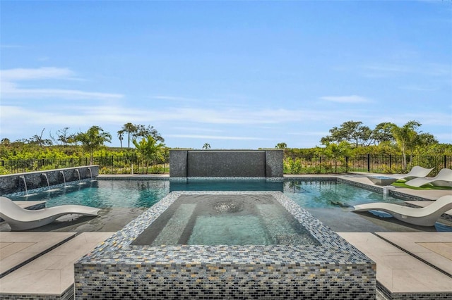 view of swimming pool featuring an in ground hot tub, pool water feature, and a patio