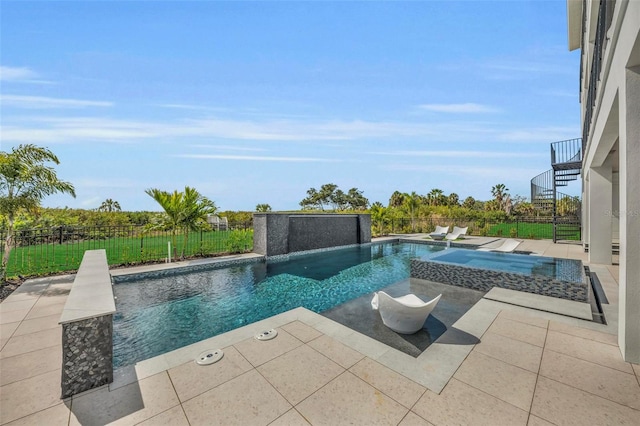 view of pool featuring a patio area and an in ground hot tub