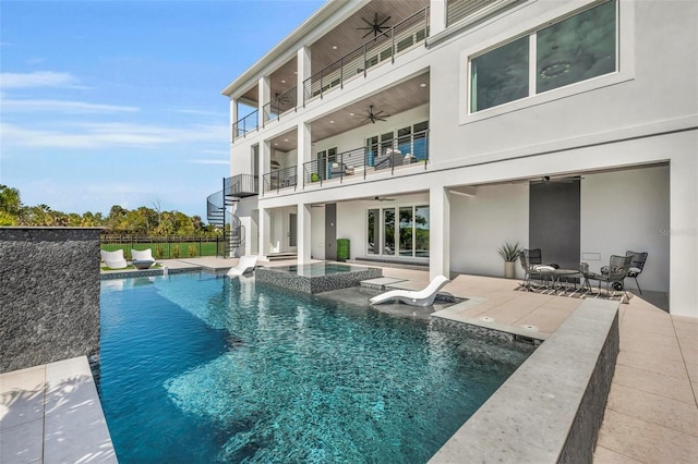 view of swimming pool featuring ceiling fan and a patio