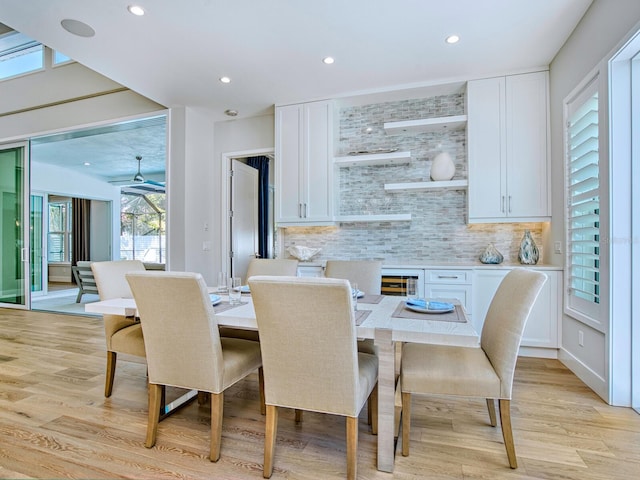 dining space with light hardwood / wood-style floors and ceiling fan