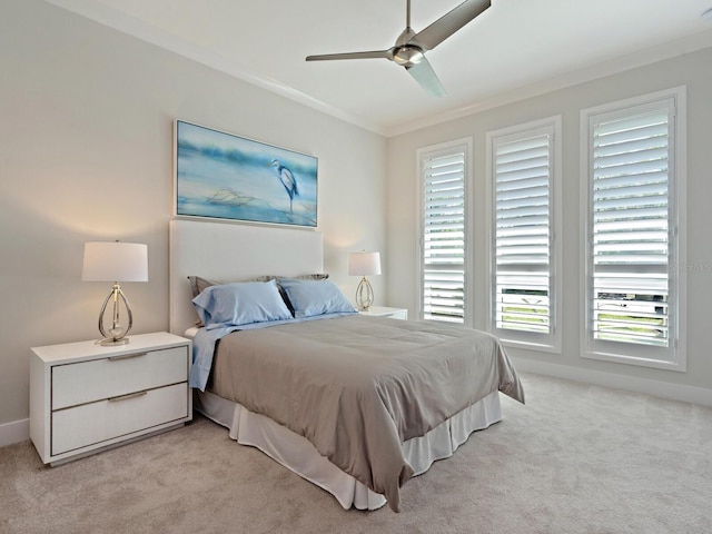 bedroom with light carpet, ornamental molding, and ceiling fan