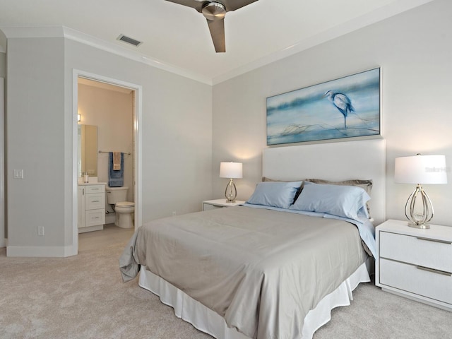 carpeted bedroom featuring ensuite bathroom, ornamental molding, and ceiling fan