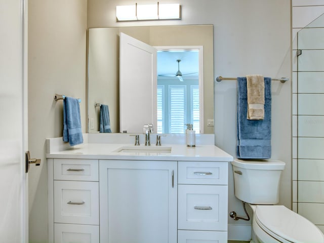 bathroom with toilet, vanity, and ceiling fan