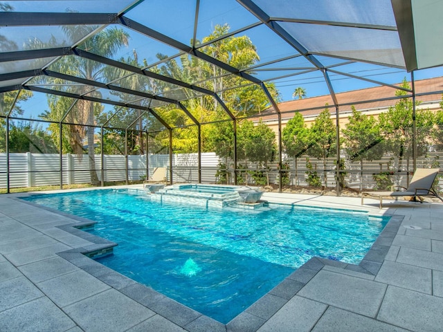 view of pool with an in ground hot tub, a patio, and a lanai