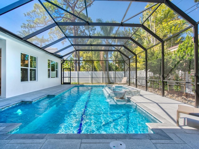 view of swimming pool with a patio, pool water feature, an outdoor hot tub, and a lanai