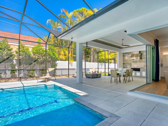 view of pool with a patio, ceiling fan, and a lanai