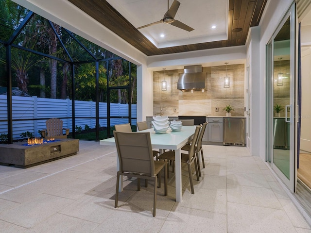 interior space featuring a raised ceiling and ceiling fan