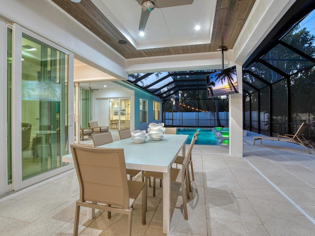 view of terrace featuring ceiling fan and a lanai