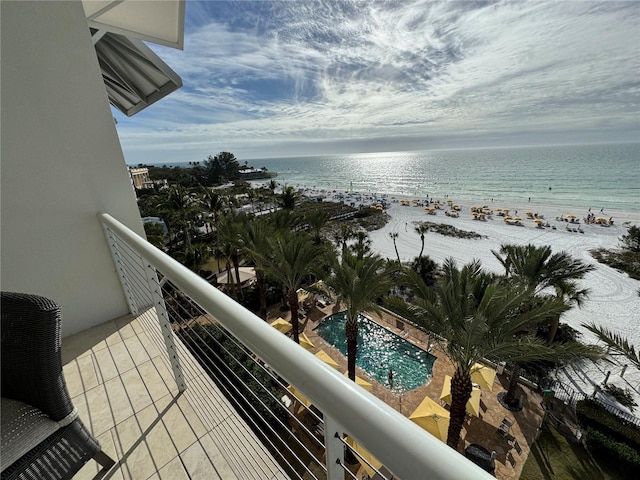 balcony featuring a community pool and a water view